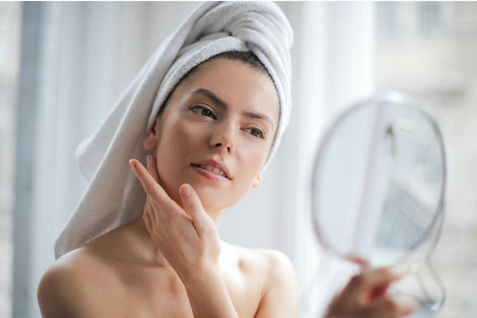 Woman Looking at Her Skin after EvolveX Treatment
